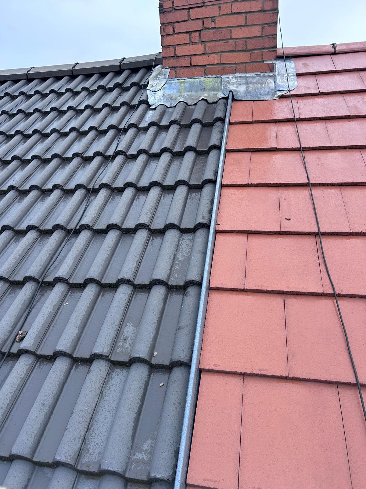 Concrete tile roof with leadwork around chimney