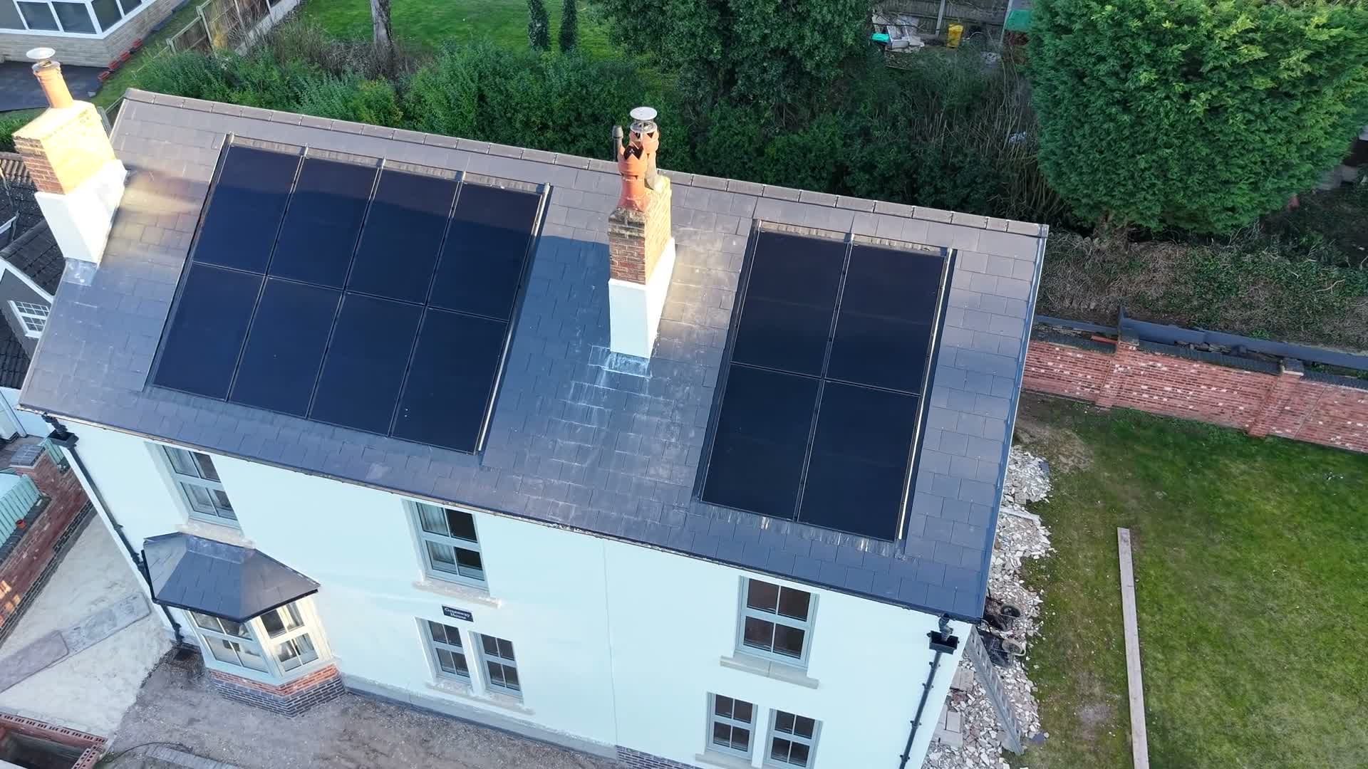 Aerial drone view of a completed WeatherTech slate roof with integrated solar panels in the East Midlands